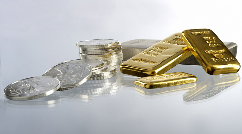 Goldbarren und Silbermünzen