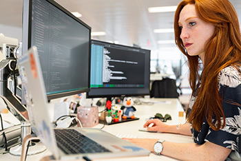 Junge Frau bedient Warenmanagement-Software.