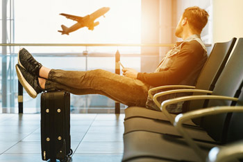Junger Mann wartet auf seinen Abflug